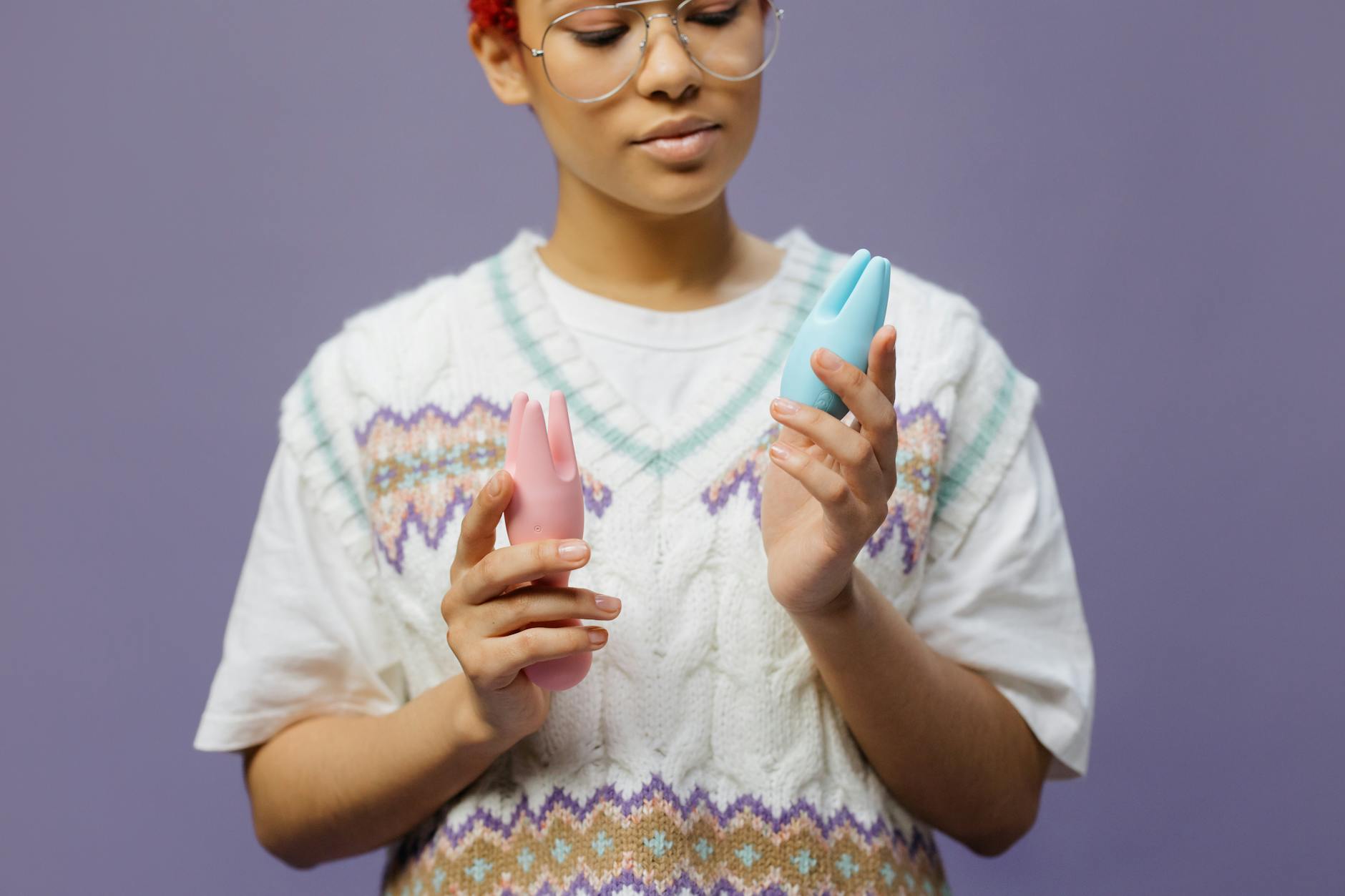 Woman holding a lemon clitoral vibrator with curiosity and openness