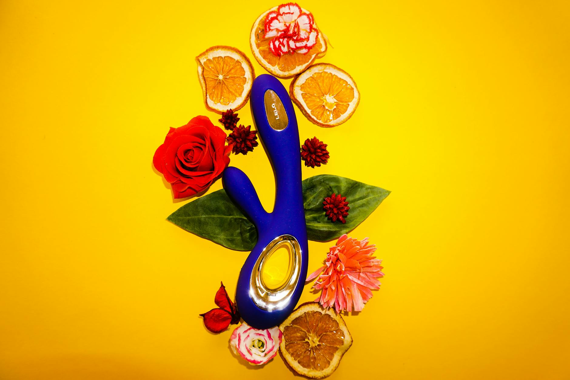 A blue silicone vibrator held gently in hand, representing a tool for managing vaginismus and penetration anxiety.